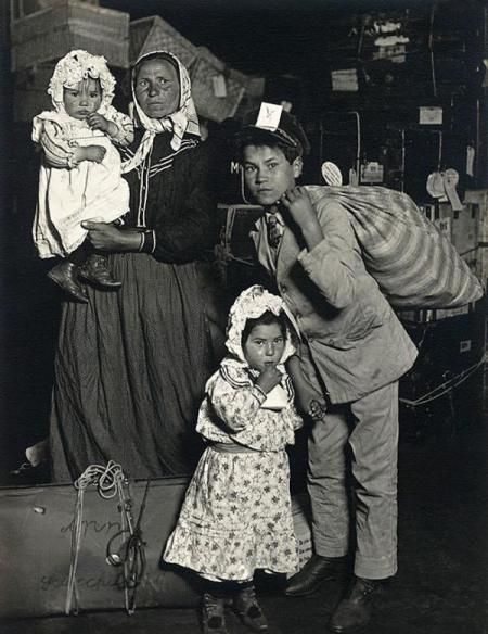 Italian family at Ellis Island. New York, 1905. By Lewis W. Hine