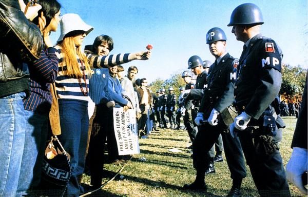 Anti-Vietnam demonstrator offers a flower to a miltary police, Arlington, Virginia, October 21, 1967