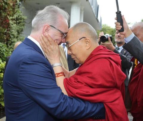 picture of the Dalai Lama touching Richard's head when he welcomed him at City of Derry airport in 2007