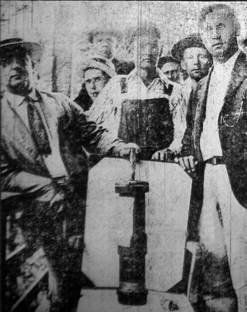 A group of miners display one of the bombs dropped by Chafin's airplanes