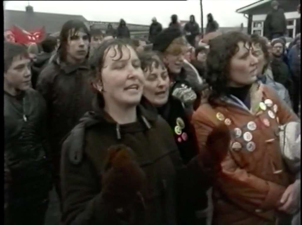 A group of women sing to police at the Hatfield Main picket line in Here We Go (Richard Hines & Banner Film and Television, 1985)