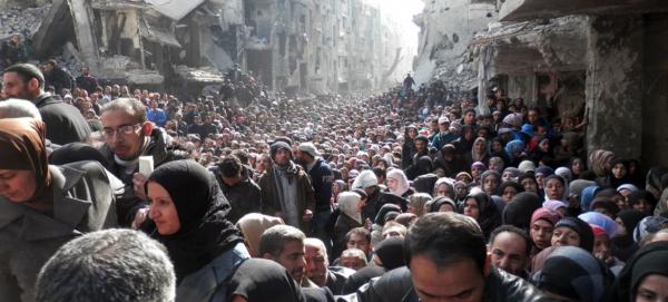  Palestinian refugee camp Yarmouk in Syria- Queue for food photo credit @ UNRWA Archives 