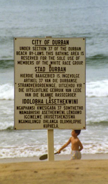 Noi non possiamo camminare liberi. Un avviso sulla spiaggia di Durban, in tre lingue (inglese, afrikaans e zulu). Tratto di spiaggia riservato ai "membri della razza bianca". La foto è del 1989.