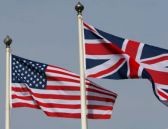 the-american-stars-and-stripes-flying-from-a-flagpole-next-to-the-union-jack-of-great-britain